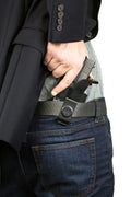 Handgun holstered beneath a black suit jacket with IWB Holster Kit for Beretta