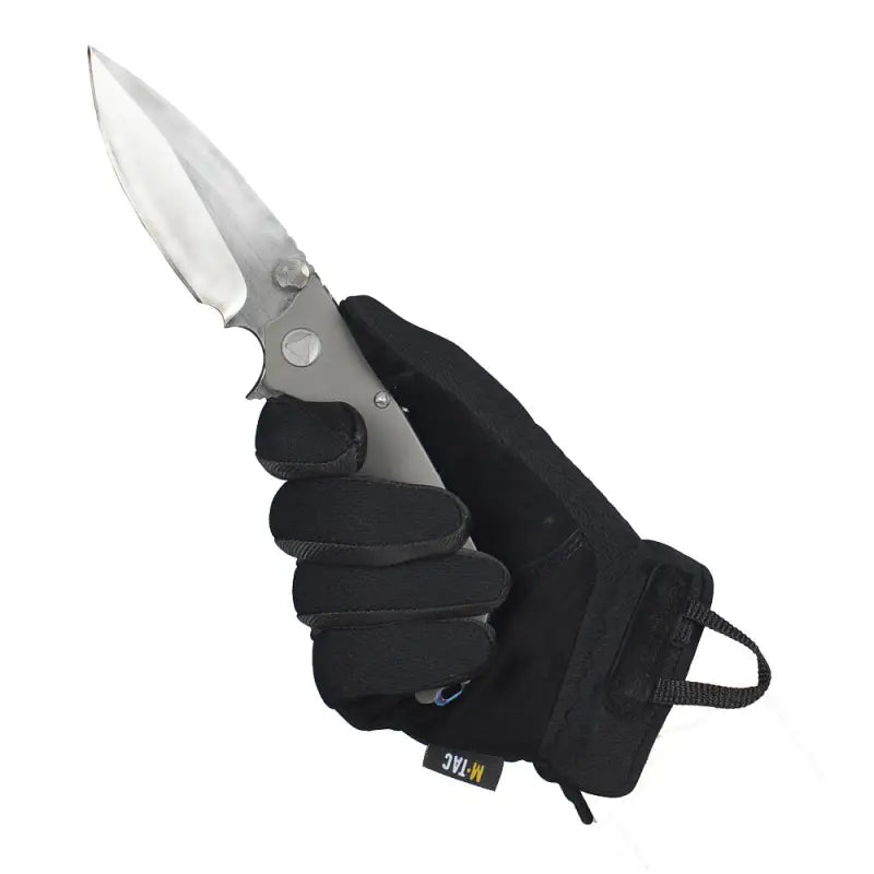 Folding knife held in black-gloved hand wearing M-Tac Gloves Scout Tactical