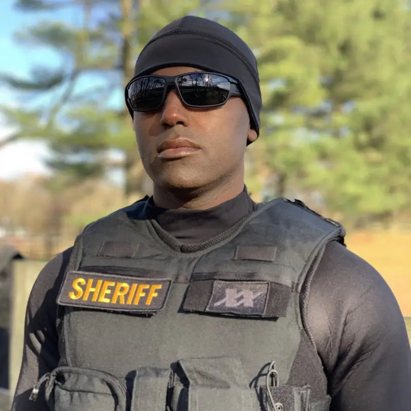 Law enforcement officer in tactical gear with Equinoxx Watch Cap Beanie and sunglasses