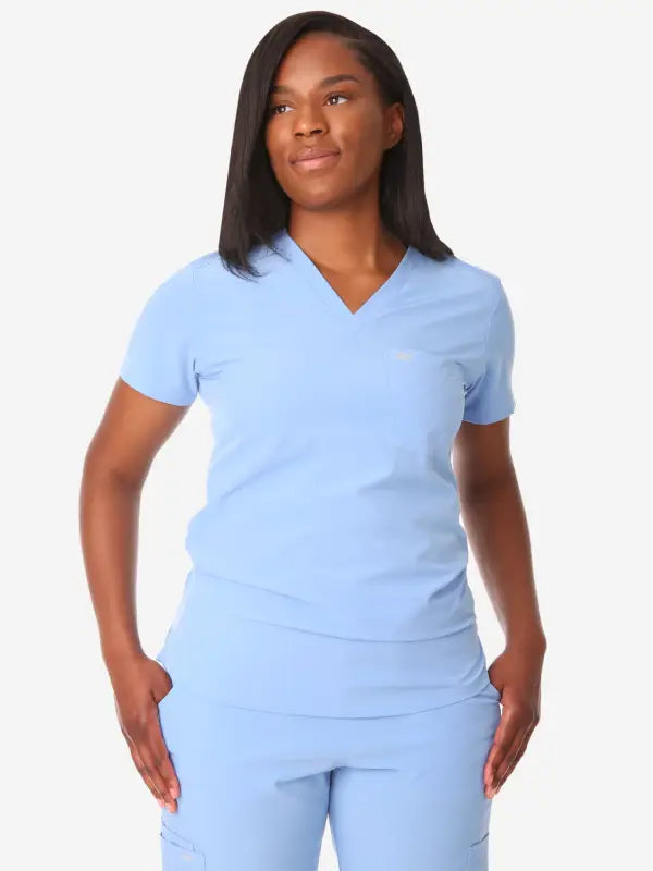 Light blue women’s tuckable one-pocket scrub uniform with v-neck top and pants