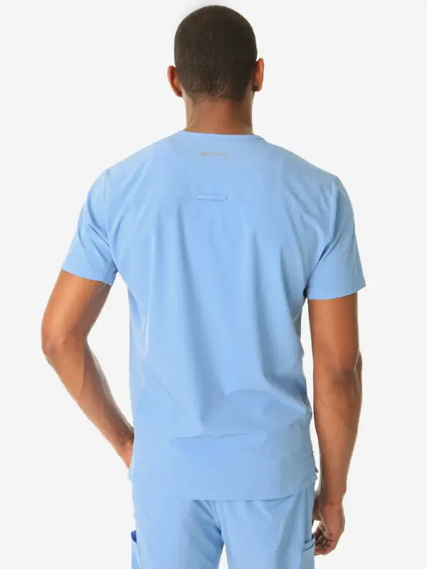 Light blue men’s double-pocket scrub top viewed from behind, showcasing comfort and style