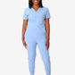 Light blue women’s stash-pocket scrub top paired with white sneakers for comfort and style