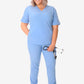 Light blue women’s stash-pocket scrub top paired with white sneakers for medical professionals