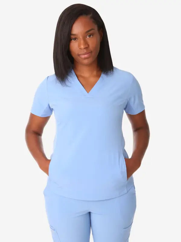 Light blue women’s stash-pocket scrub uniform with v-neck top and matching pants