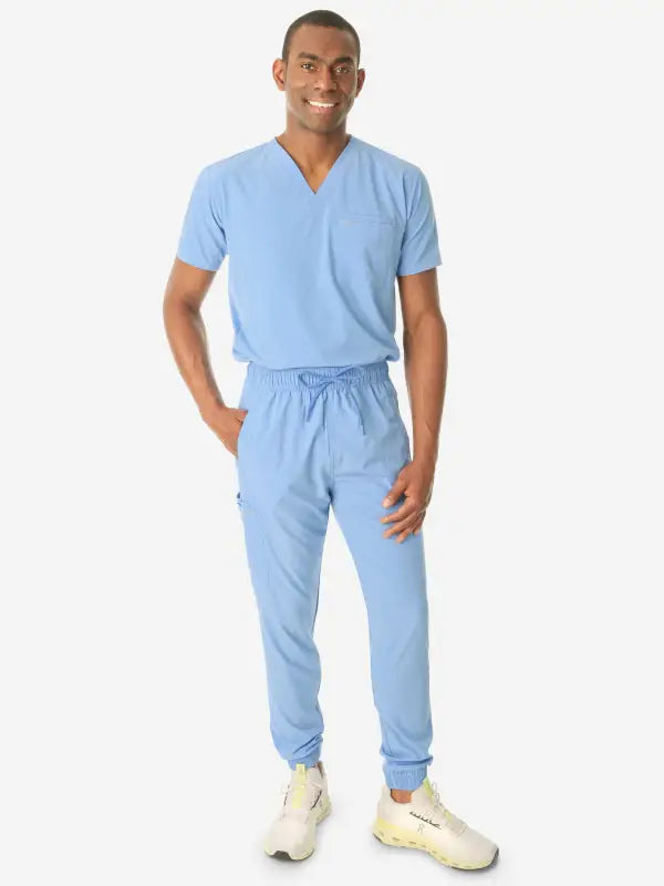 Light blue men’s double-pocket scrub uniform with v-neck top and drawstring pants