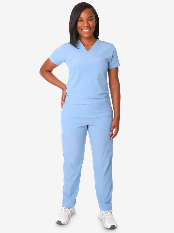 Light blue women’s tuckable one-pocket scrub top with matching pants for comfort and style