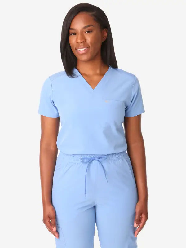 Light blue women’s tuckable one-pocket scrub top with v-neck and drawstring pants