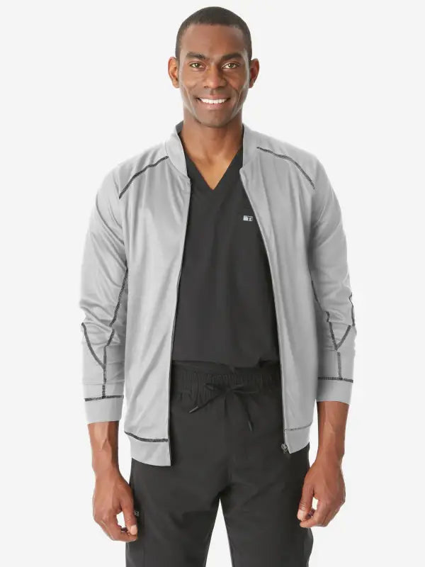 Light gray men’s scrub jacket with black trim over a black v-neck shirt