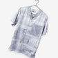 Light gray men’s duct tape scrub top with abstract geometric pattern on hanger