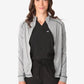 Light gray women’s scrub jacket stylishly layered over a black top for comfort