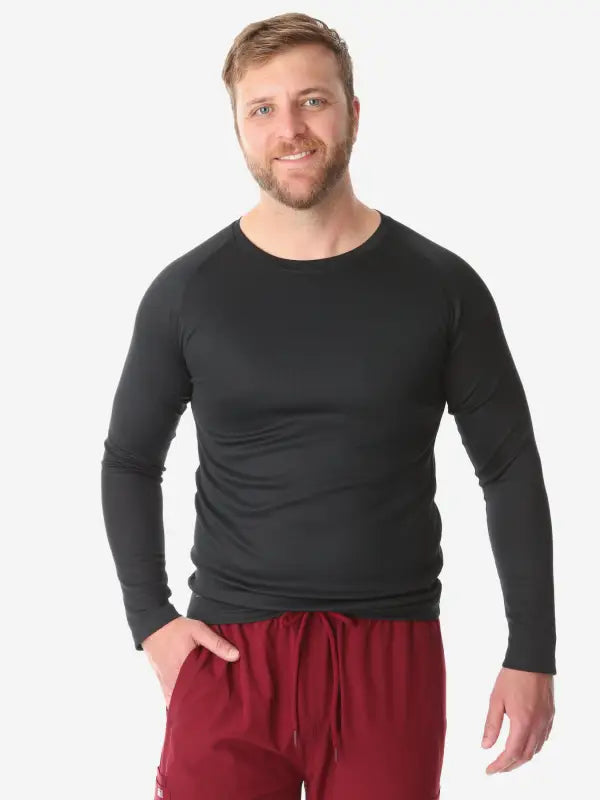 Men’s Long-Sleeve Underscrub in black paired with burgundy sweatpants for a casual look