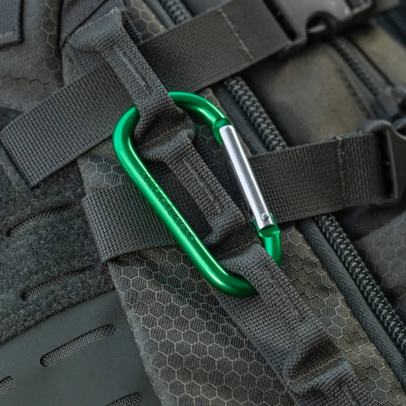 Green aluminum M-Tac carabiner clip on black webbing for first responders and firefighters