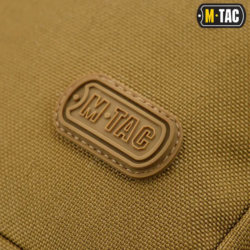 Brown rubber M-Tac logo patch with stitched border on M-Tac Concealed Carry Sling Bag Elite