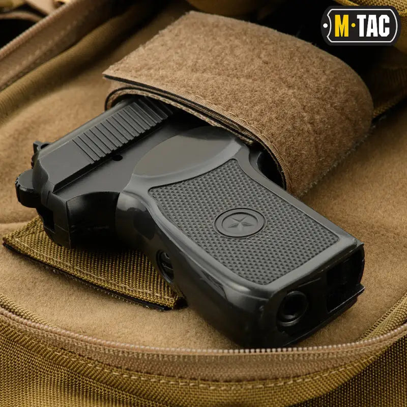 Black pistol in tan tactical holster of M-Tac Concealed Carry Sling Bag Elite Gen.IV