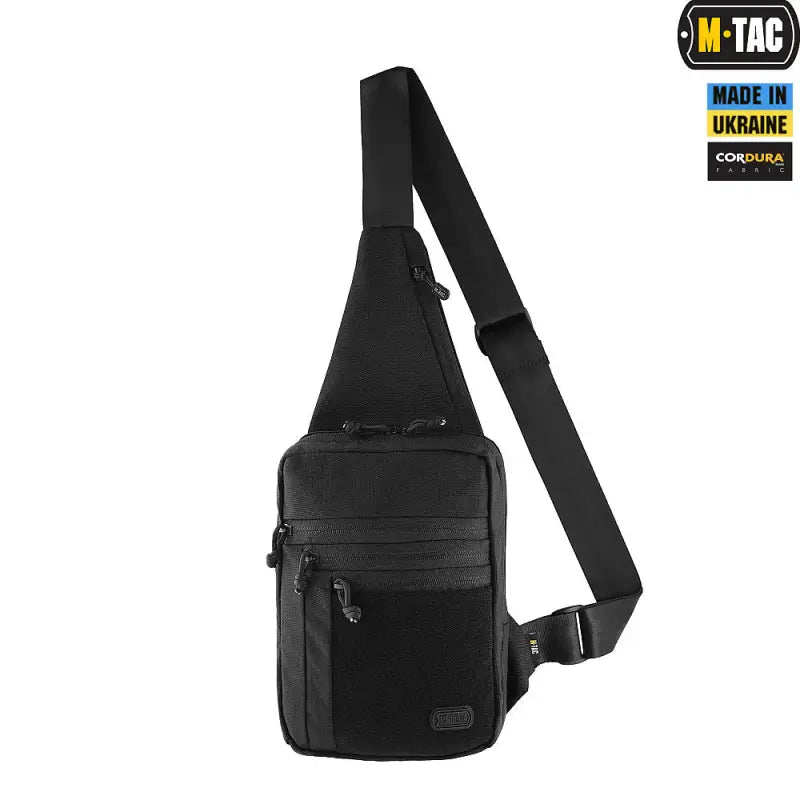 Black tactical carry sling bag elite with zippered compartments and adjustable strap