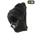 Black synthetic leather M-Tac gloves Assault holding a compact flashlight
