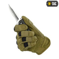 Tactical gloved hand gripping a knife blade with M-Tac Gloves Assault features