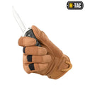 Tan synthetic leather glove holding a knife blade from M-Tac Gloves Assault Tactical Mk.6