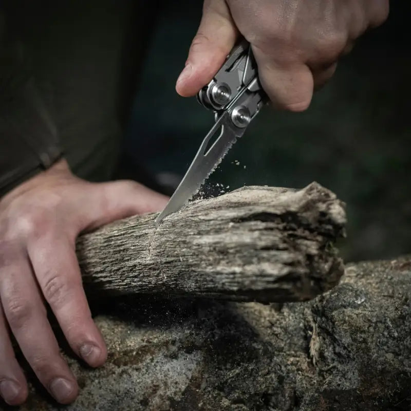 M-Tac Multitool Type 3 Grey cutting wood with a versatile pocket knife