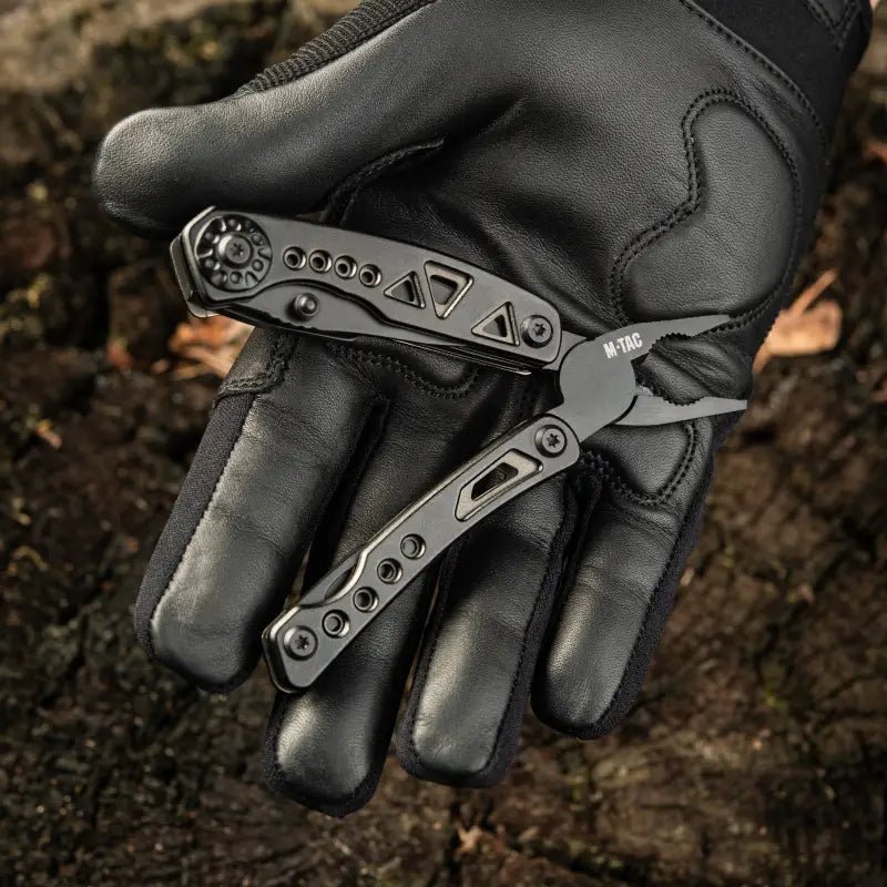 Black butterfly knife on a leather glove, showcasing M-Tac Multitool Type 6 design