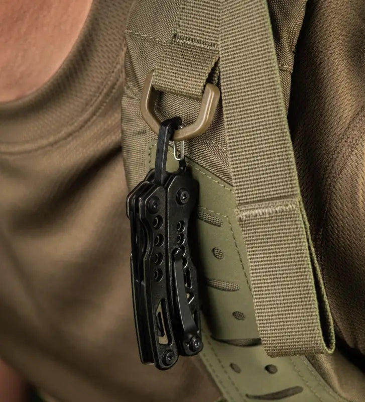 Black M-Tac Multitool Type 6 clipped to tan tactical strap, made of stainless steel