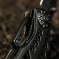Black guitar headstock with tuning pegs on M-Tac Multitool Type 6 Black/Olive