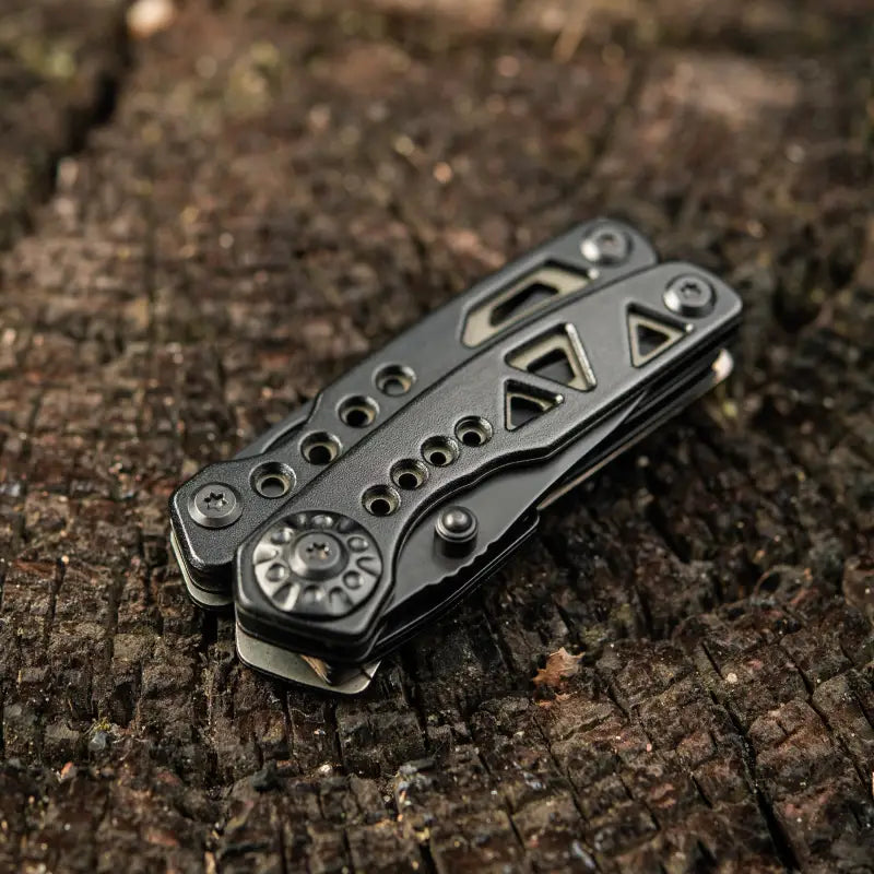 Black metal folding pocket knife of M-Tac Multitool Type 6 with circular pivot design