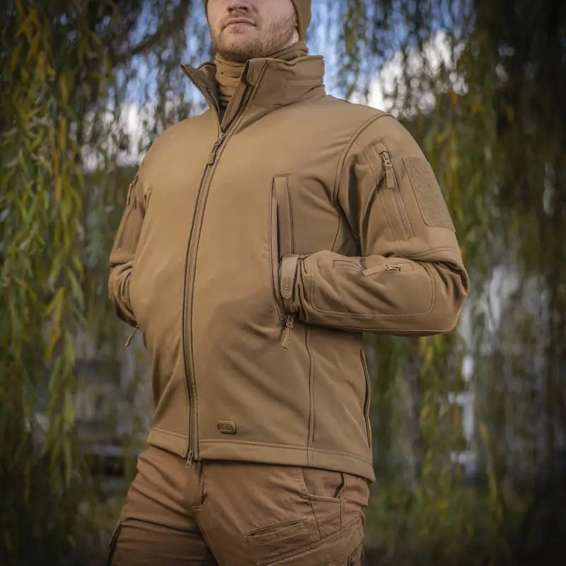 Tan M-Tac Soft Shell Jacket with multiple zippered pockets and two shoulder pockets