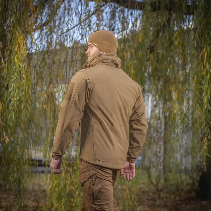 Person in brown M-Tac Soft Shell Jacket with two shoulder pockets seen from behind