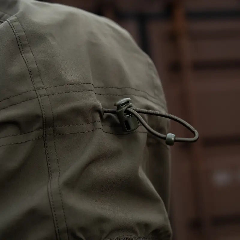 Olive-green M-Tac Soft Shell Jacket with drawstring cord and toggle adjuster