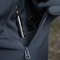 Black tactical pen in zippered pocket of M-Tac Soft Shell Jacket with two shoulder pockets