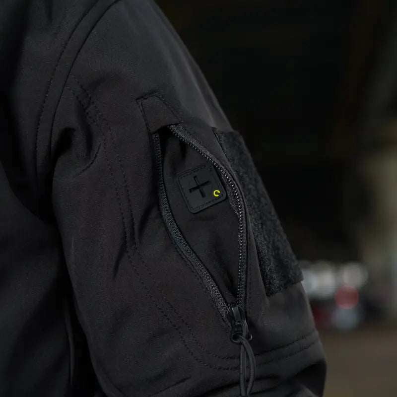 Black sleeve of M-Tac Soft Shell Jacket featuring a zipper pocket and two shoulder pockets