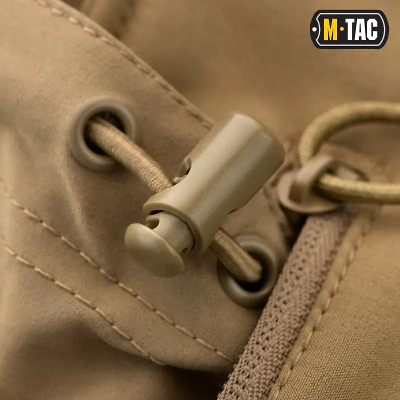 Tan cord lock on M-Tac Soft Shell Jacket with Liner near zipper and grommets