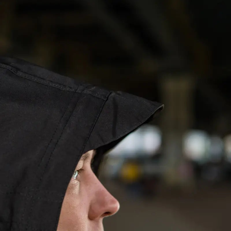 Profile view of a black graduation cap on a model wearing M-Tac Soft Shell Jacket