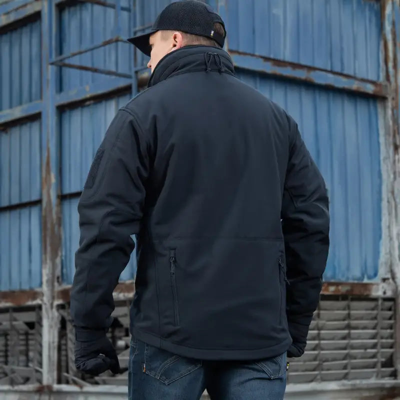 Black M-Tac Soft Shell Jacket with two shoulder pockets worn casually outdoors