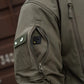 Olive green M-Tac Soft Shell Jacket sleeve with two shoulder pockets and velcro patches