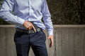 Black handgun in Mainstay Clipless IWB Holster with dress pants and shirt