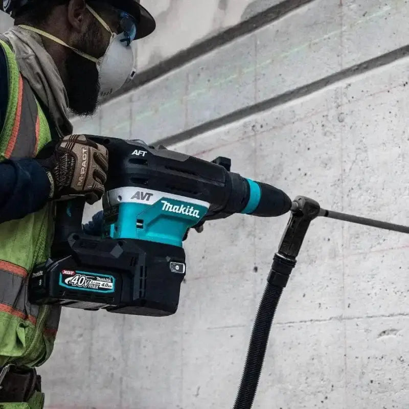 Makita GRH05M1 40V Max XGT® Brushless AVT® Rotary Hammer drilling into concrete surface