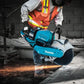 Makita GEC01PL4 80V XGT® Brushless Power Cutter cutting concrete with flying sparks