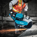 Makita GEC01PL4 80V XGT® Brushless Power Cutter cutting concrete with flying sparks