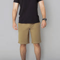 Man wearing black T-shirt and khaki Carrier Shorts Mk.II for concealed carry in Arrowhead Tactical Apparel