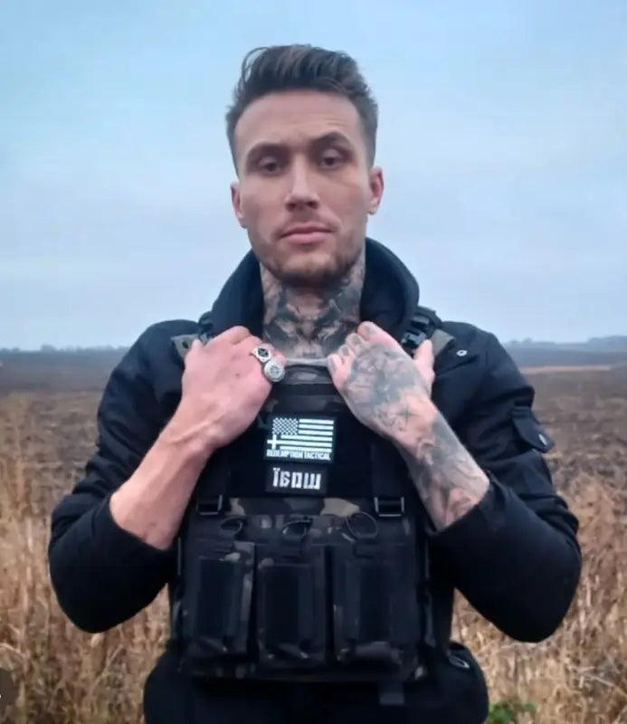 Man wearing black tactical vest with American flag patch in redemption tactical body armor large size