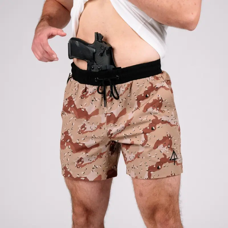 Man wearing Carrier Training Shorts 5 inch inseam with concealed carry and camouflage pattern