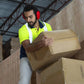 Man lifting cardboard boxes while wearing 23dB NRR noise cancelling hearing protection earmuffs