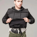 Man demonstrating concealed carry in hand pocket of Standoff Concealment Hoodie Mk.II