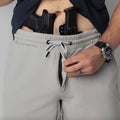Man with concealed handgun and magazine wearing Carrier Shorts Mk.II for concealed carry