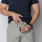 Man adjusting gray Carrier Shorts Mk.II for concealed carry by Arrowhead Tactical Apparel
