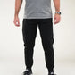 Man in gray t-shirt and black joggers featuring Carrier Traveler Joggers with concealed carry