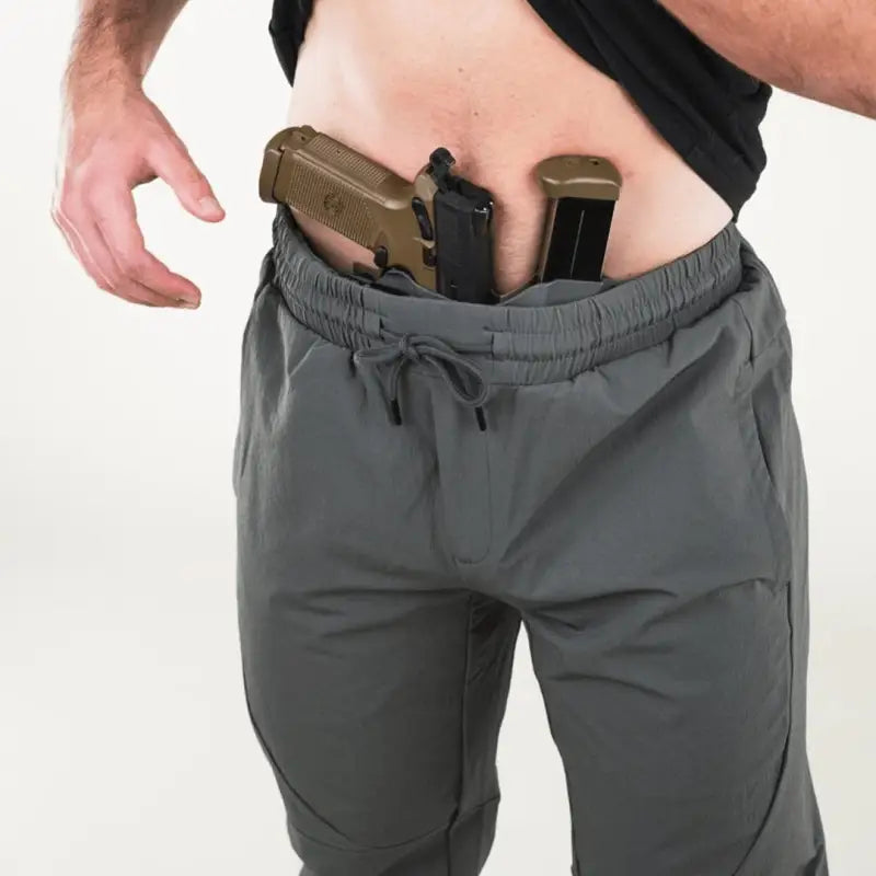 Man with concealed carry gun in carrier retention waistband wearing Traveler Joggers