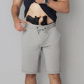 Man with gun and magazine in waistband wearing Carrier Shorts Mk.II for concealed carry